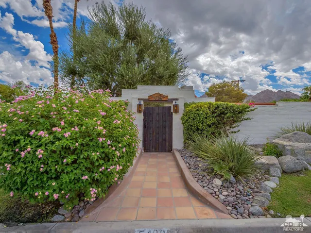 a view of a pathway both side of the yard
