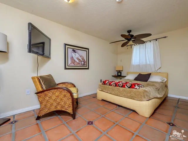 a bedroom with furniture and a flat screen tv