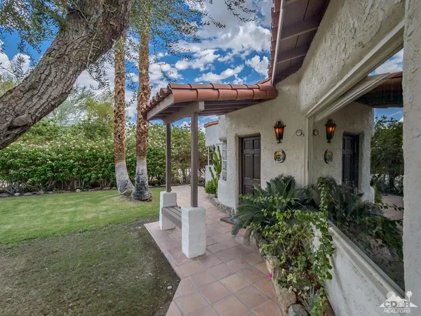 a living room with furniture rug and wooden floor