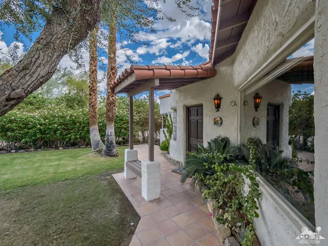 a living room with furniture rug and wooden floor