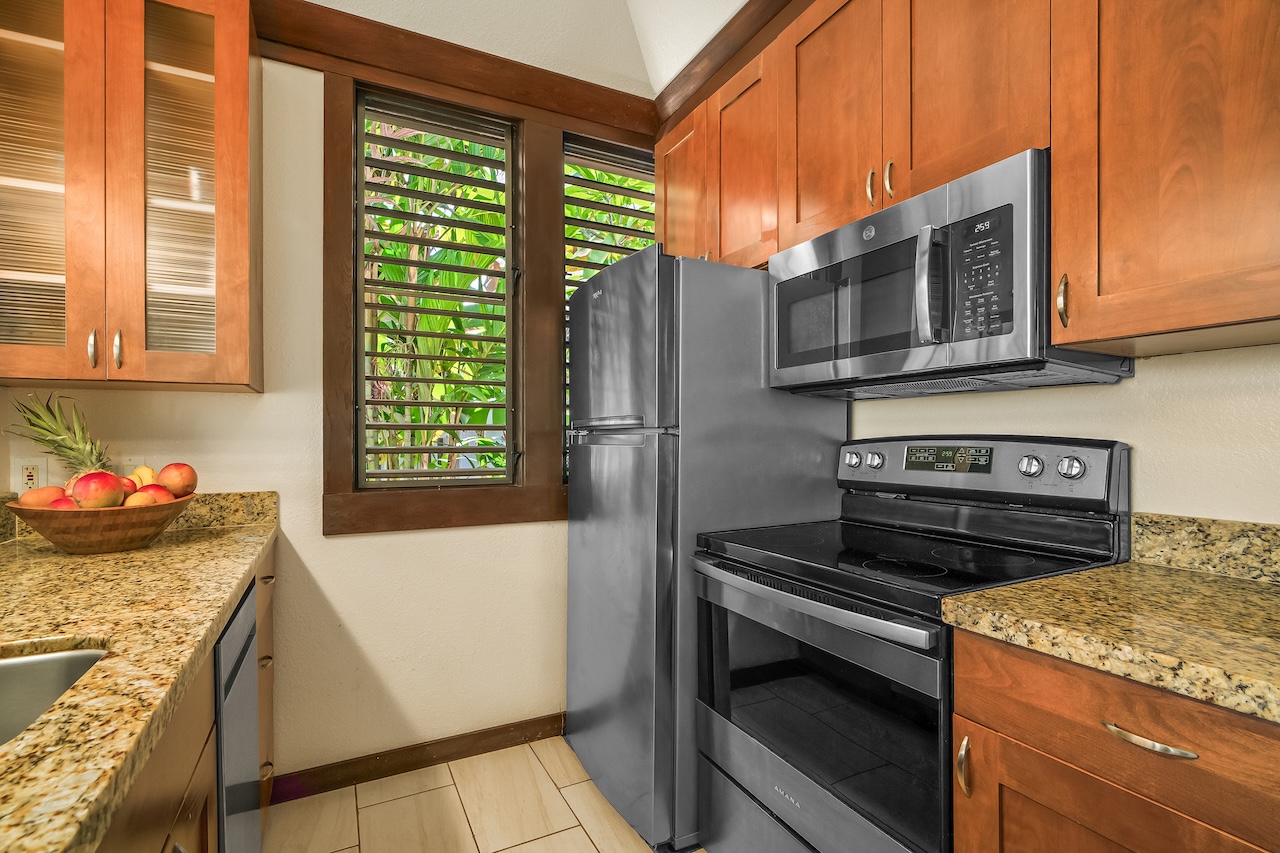2253 Poipu Road, Unit 115 Koloa, HI 96756 - Photo 11 of 24 a kitchen with a stove and a microwave