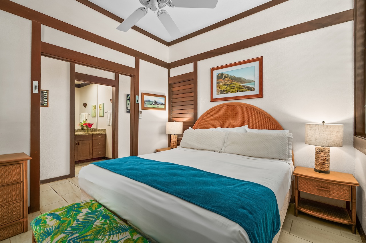 2253 Poipu Road, Unit 115 Koloa, HI 96756 - Photo 14 of 24 a bedroom with a large bed and a chandelier