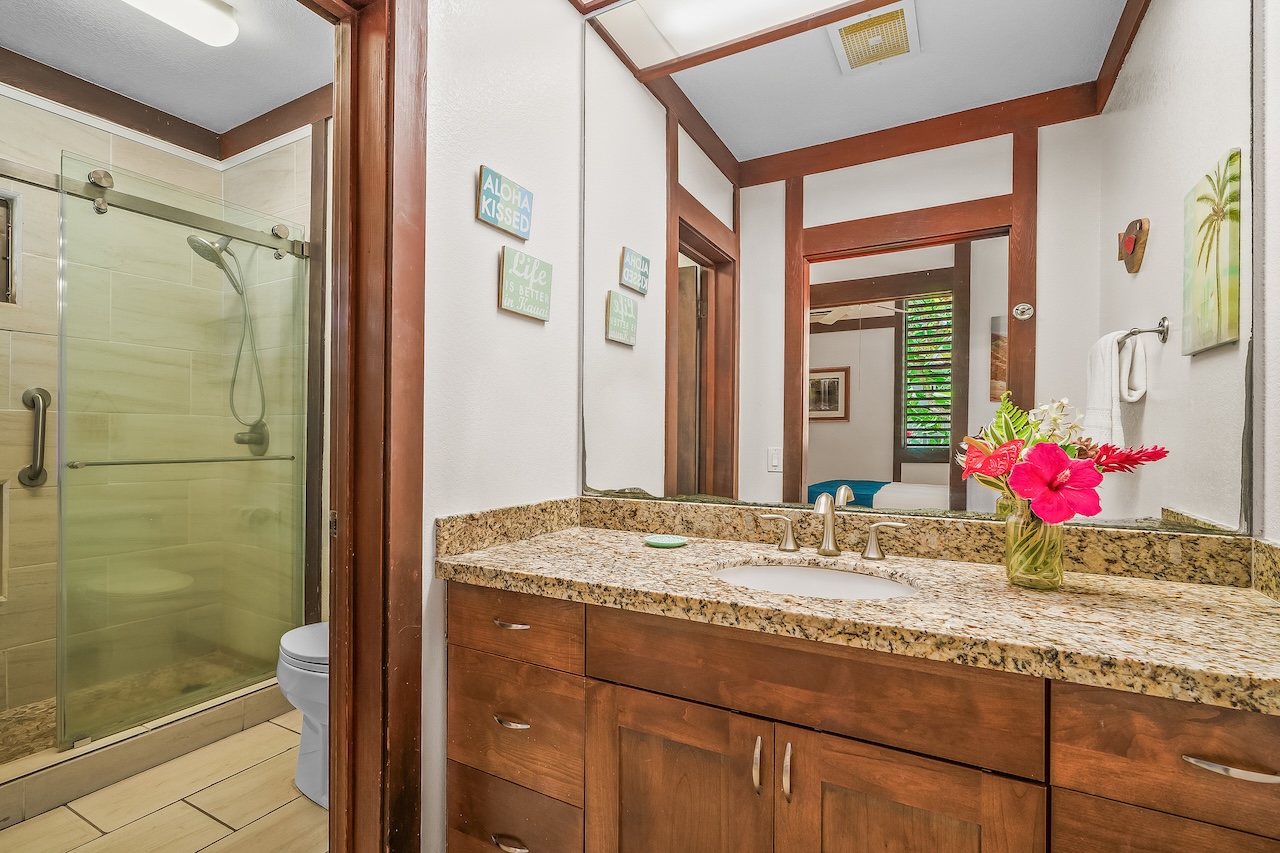 2253 Poipu Road, Unit 115 Koloa, HI 96756 - Photo 16 of 24 a bathroom with a granite countertop sink mirror and shower