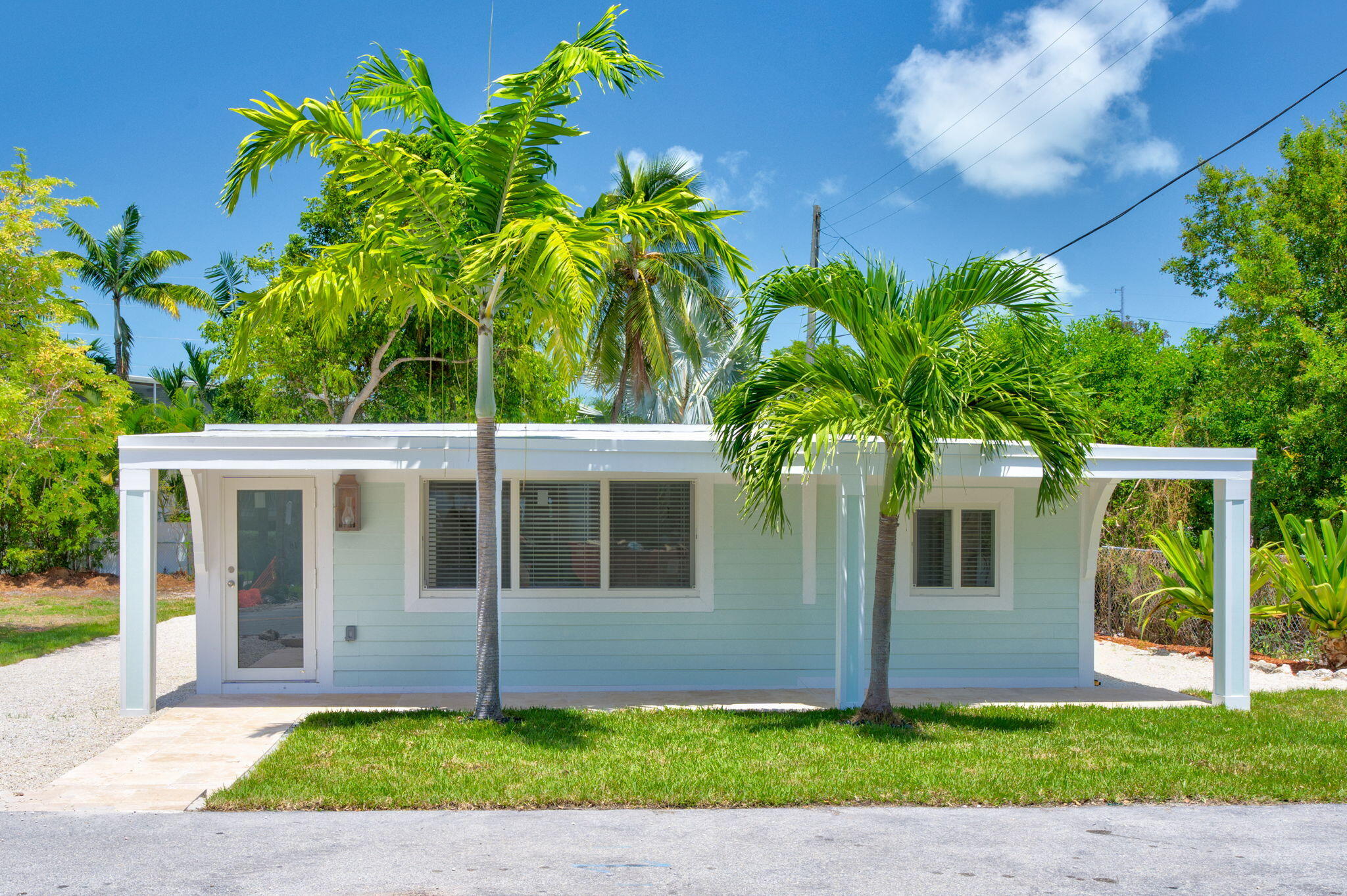 15 Seaside Avenue Key Largo, FL 33037 - Photo 5 of 39 a front view of a house with a yard and a porch