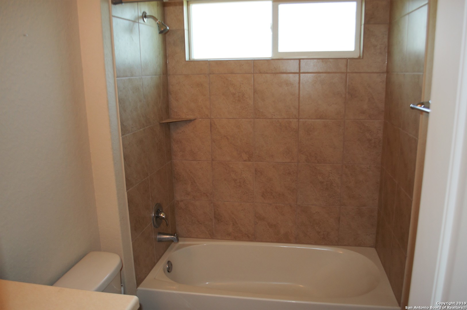 1623 Tree San Antonio, TX 78245 - Photo 15 of 21 a bathroom with a bathtub and a shower