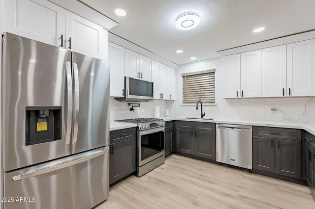 a kitchen with a sink cabinets and window
