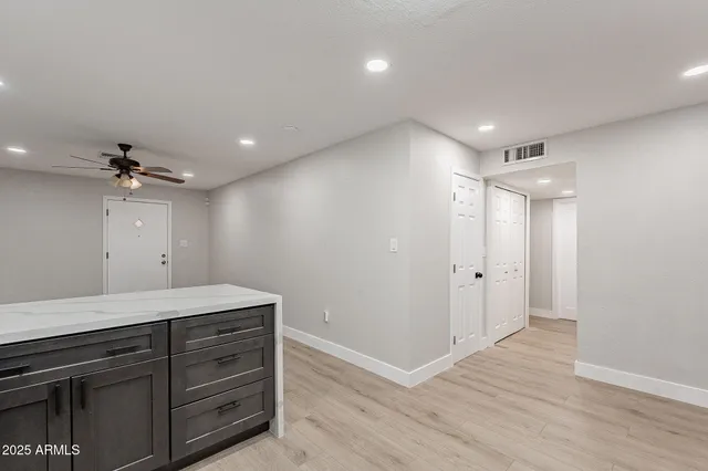 a kitchen with stainless steel appliances a stove a microwave and a hard wood floors