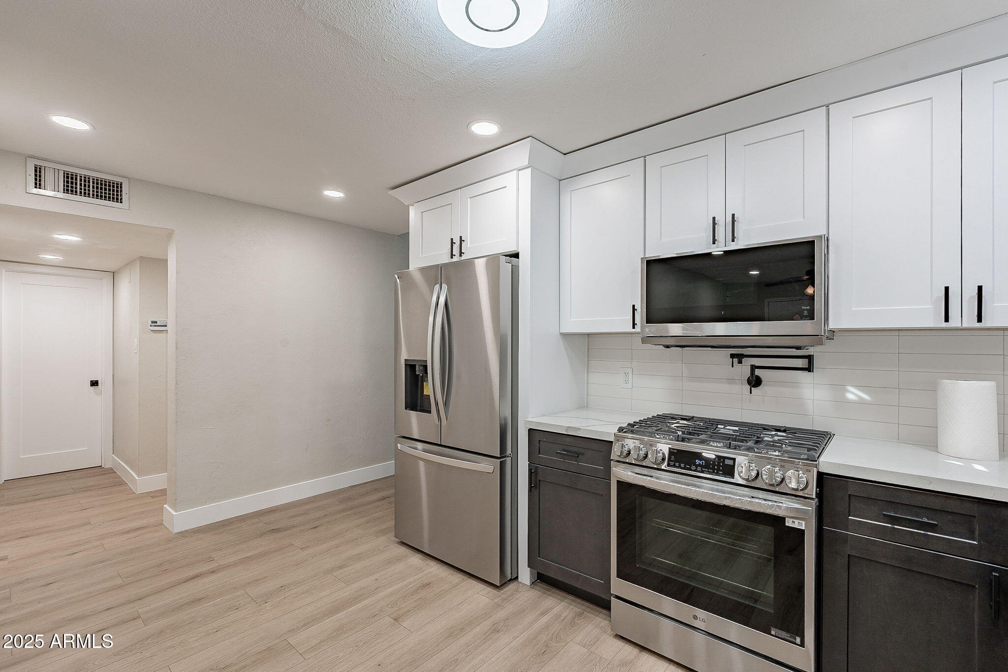 745 East Pierce Street Phoenix, AZ 85006 - Photo 14 of 39 a kitchen with stainless steel appliances a stove a microwave and a hard wood floors