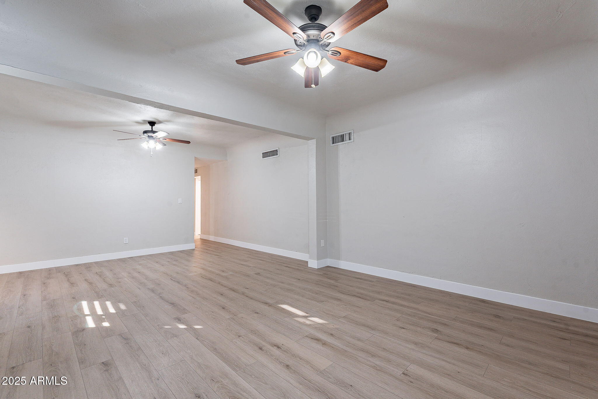 745 East Pierce Street Phoenix, AZ 85006 - Photo 17 of 39 a view of empty room with wooden floor