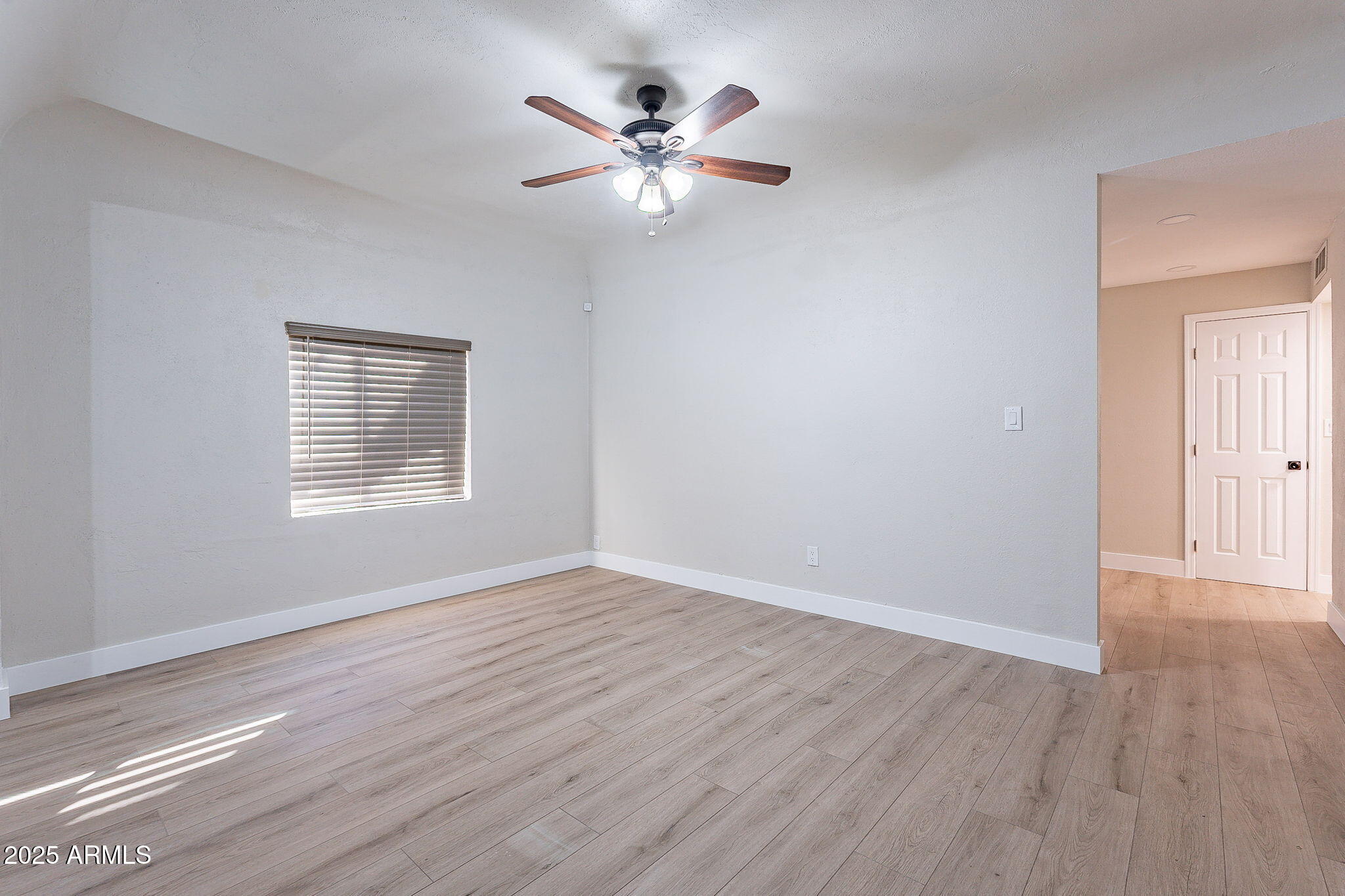 745 East Pierce Street Phoenix, AZ 85006 - Photo 18 of 39 a view of an empty room with wooden floor and a window