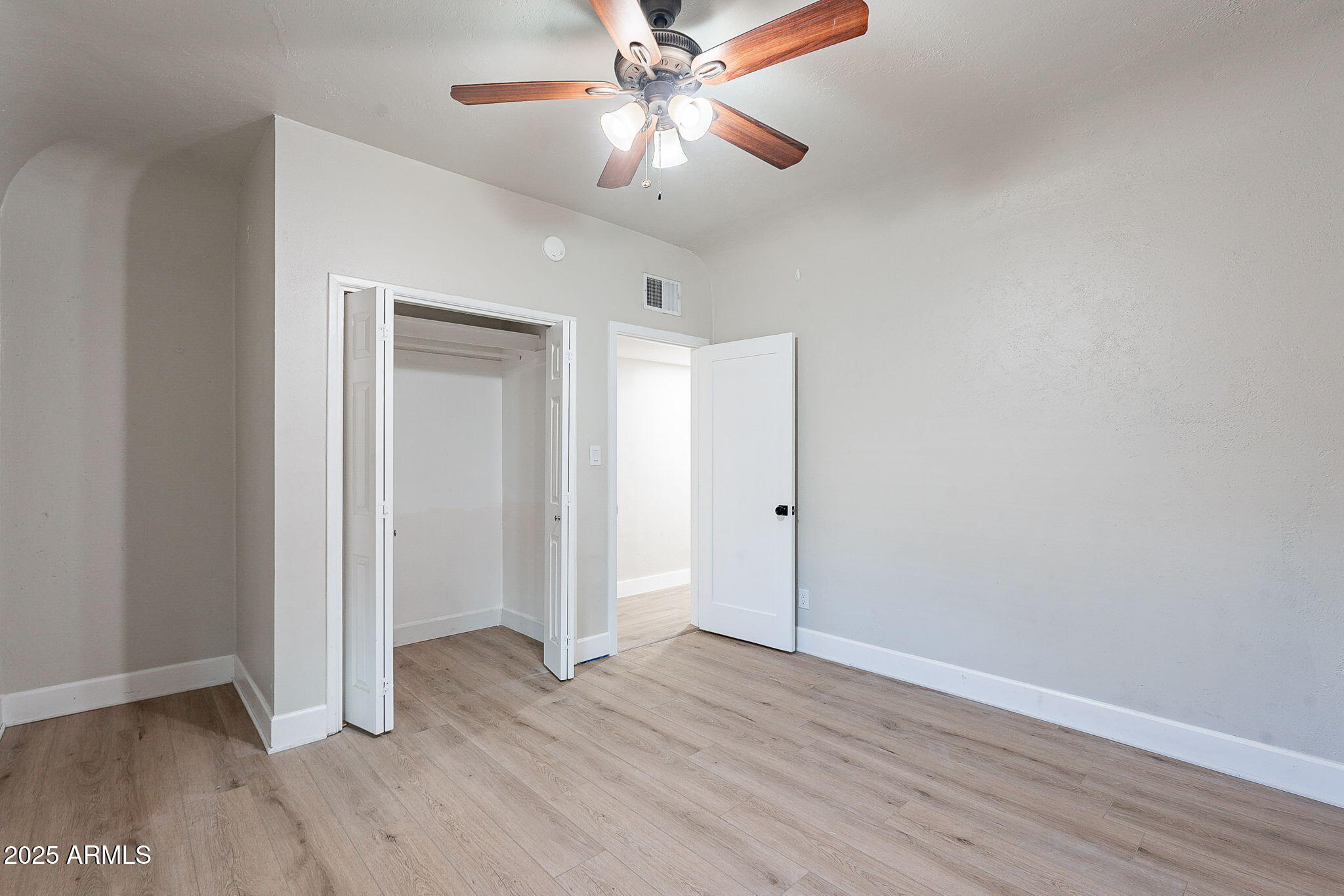 745 East Pierce Street Phoenix, AZ 85006 - Photo 23 of 39 wooden floor in an empty room with a window