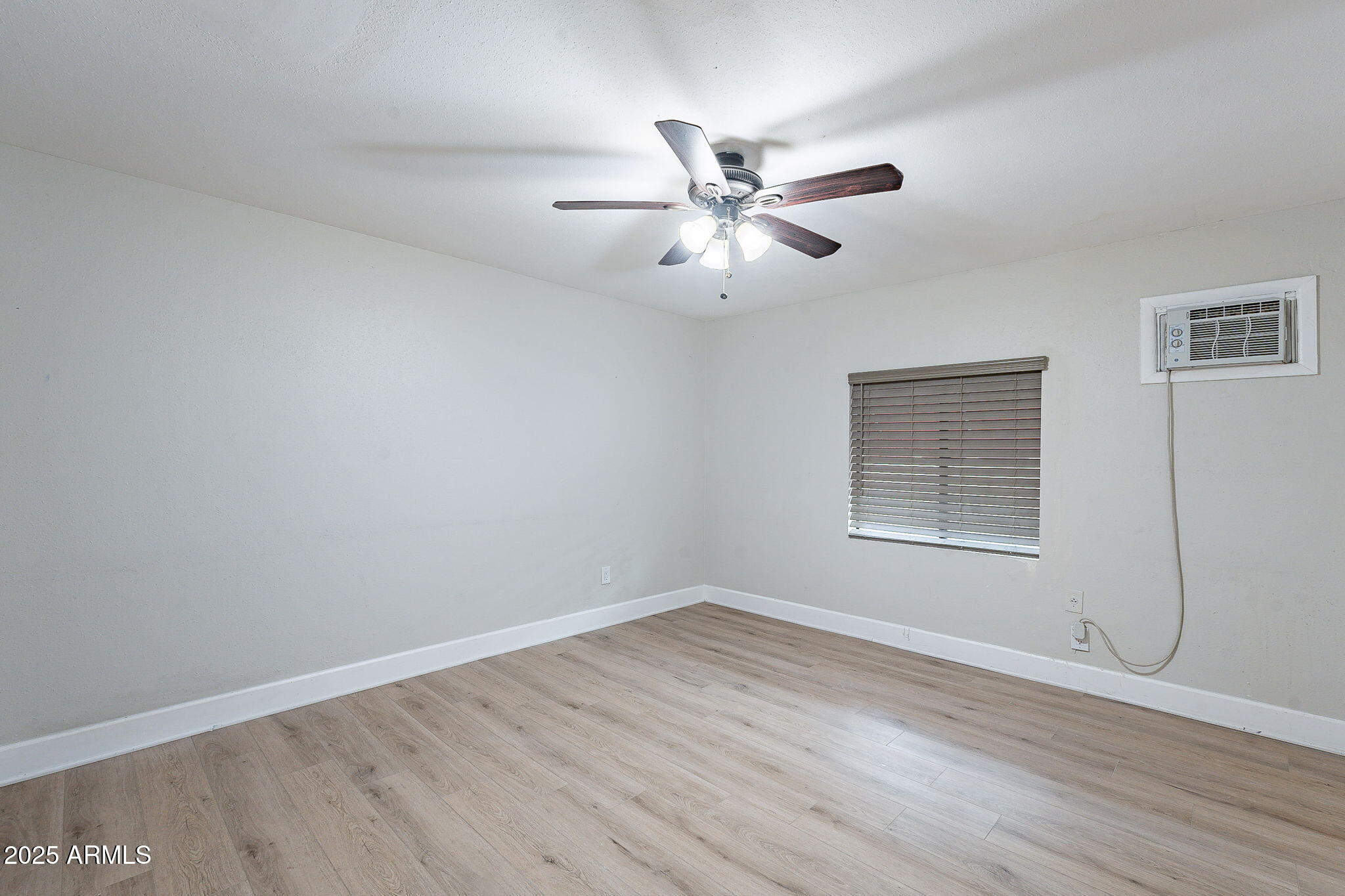 745 East Pierce Street Phoenix, AZ 85006 - Photo 26 of 39 a view of empty room with wooden floor and fan