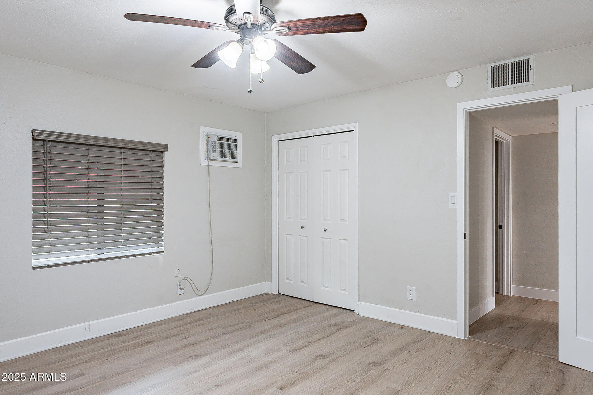 745 East Pierce Street Phoenix, AZ 85006 - Photo 27 of 39 a view of an empty room with a window and wooden floor