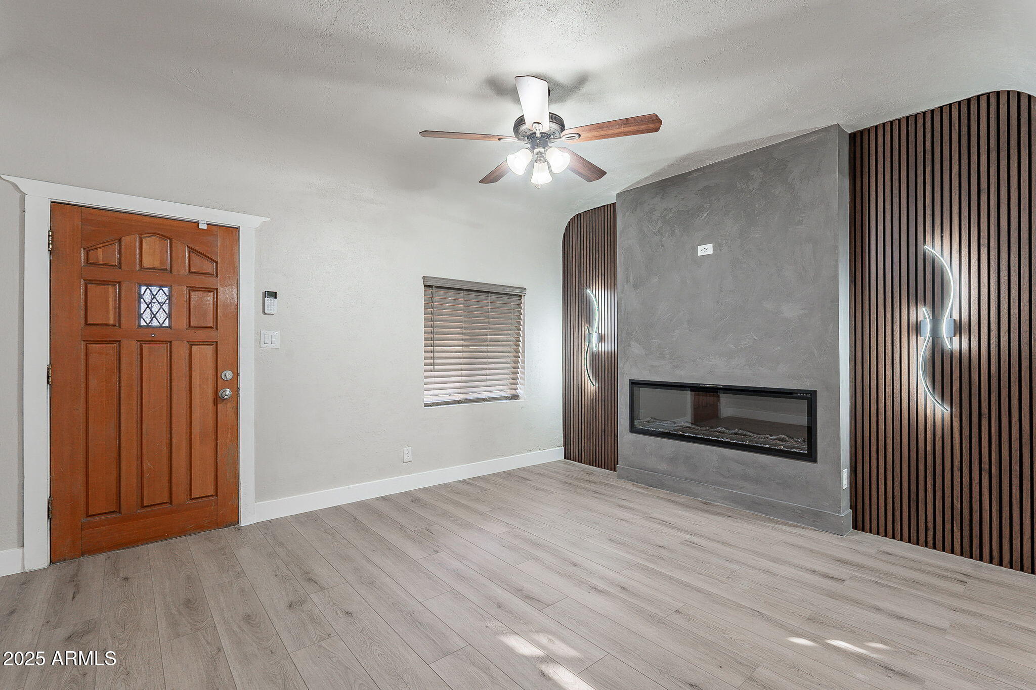 745 East Pierce Street Phoenix, AZ 85006 - Photo 6 of 39 a view of an empty room with wooden floor and a ceiling fan
