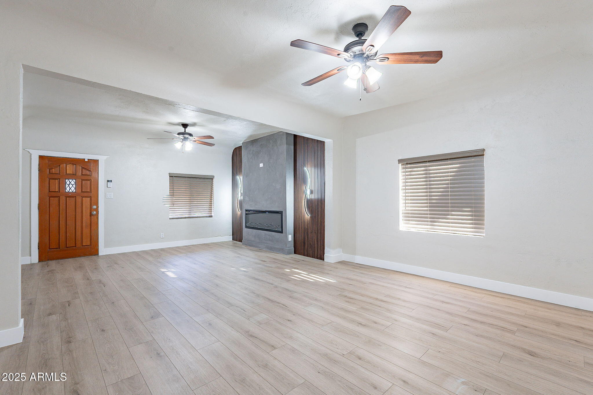 745 East Pierce Street Phoenix, AZ 85006 - Photo 7 of 39 a view of an empty room with window and wooden floor