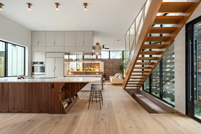 a dining hall with wooden floors and wooden cabinets