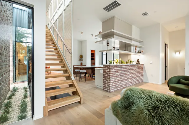 a view of hallway with wooden floor and dining room