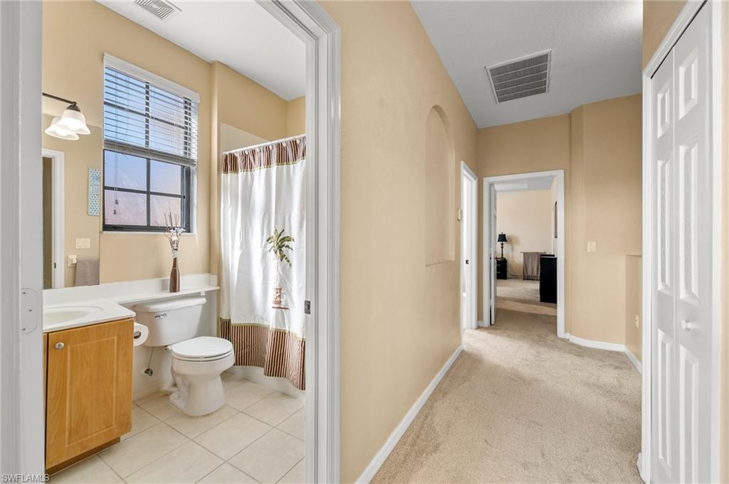 7357 Bristol Circle Naples, FL 34120 - Photo 21 of 44 a bathroom with a toilet sink and a shower