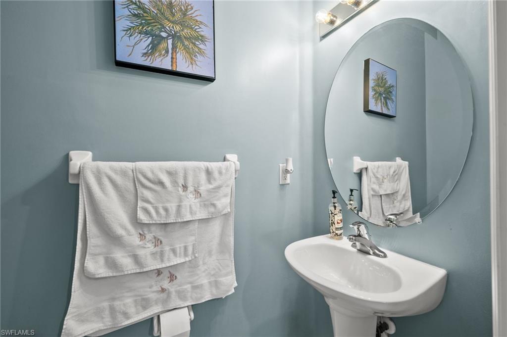 7357 Bristol Circle Naples, FL 34120 - Photo 25 of 44 a bathroom with a sink and a mirror