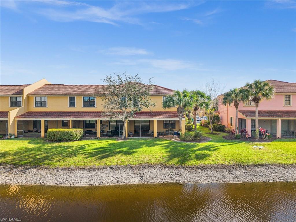 7357 Bristol Circle Naples, FL 34120 - Photo 27 of 44 a front view of a house with a garden and swimming pool