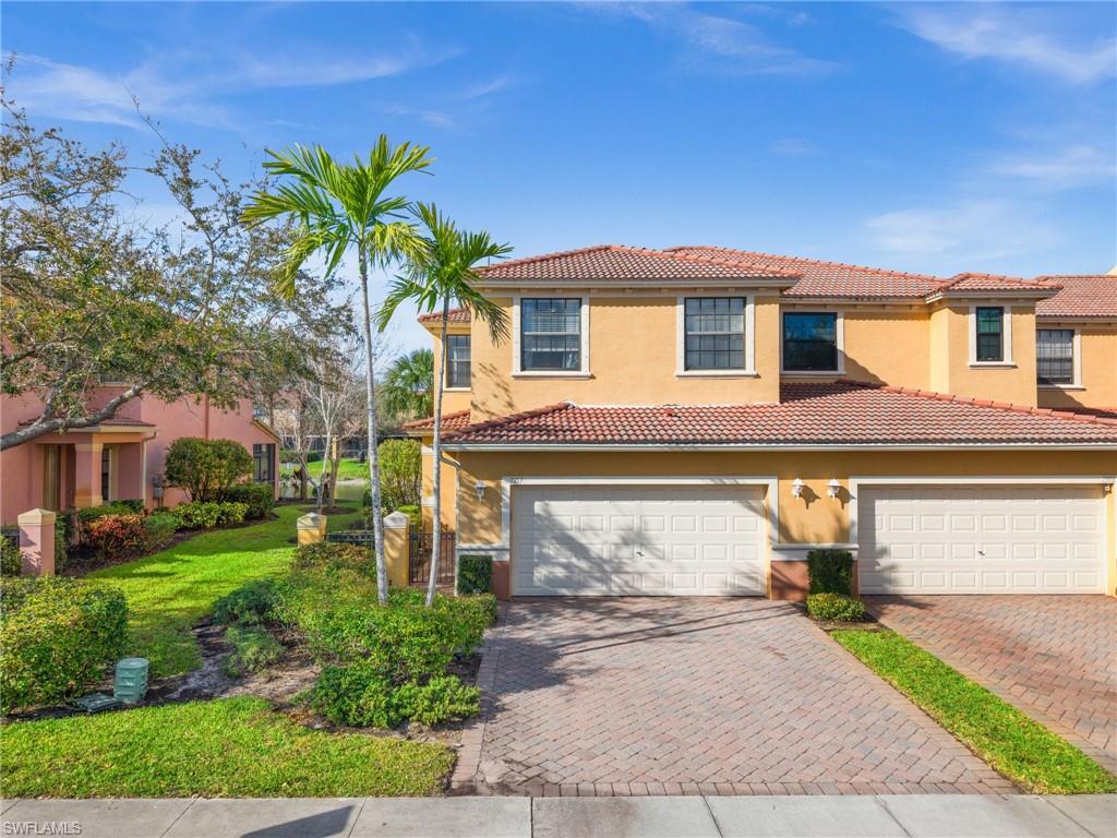 7357 Bristol Circle Naples, FL 34120 - Photo 4 of 44 a front view of a house with a yard and garage