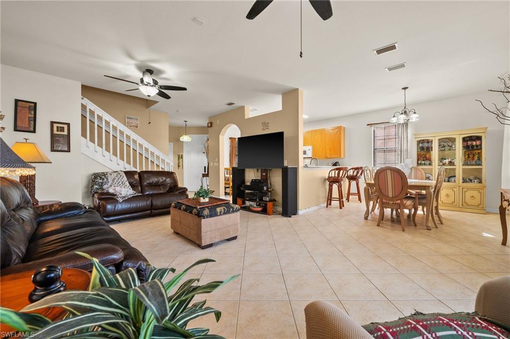 7357 Bristol Circle Naples, FL 34120 - Photo 7 of 44 a living room with furniture kitchen view and a wooden floor