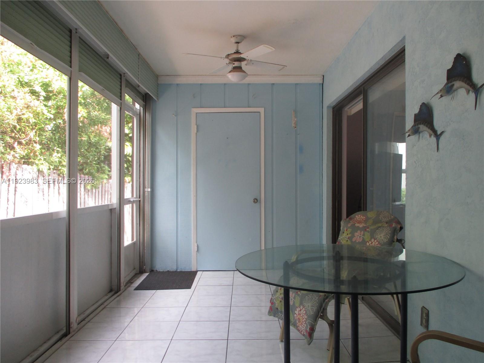 6531 Southeast Federal Highway, Unit D 112 Stuart, FL 34997 - Photo 17 of 33 SCREENED SUNROOM WITH AN ADDED STORAGE ROOM