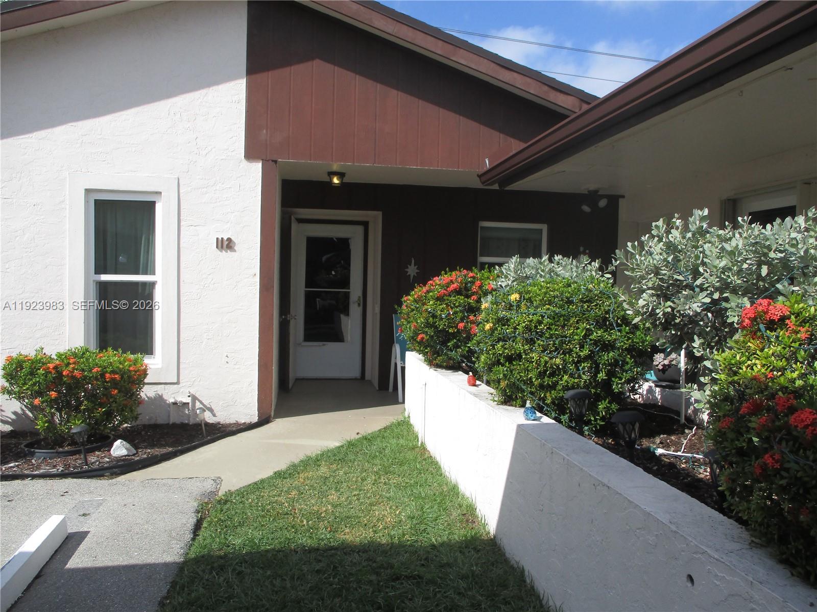 6531 Southeast Federal Highway, Unit D 112 Stuart, FL 34997 - Photo 18 of 33 ENTRANCE TO VILLA WITH COVERED PARKING IN FRONT OF VILLA