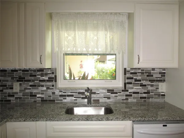 a kitchen with sink cabinets and window