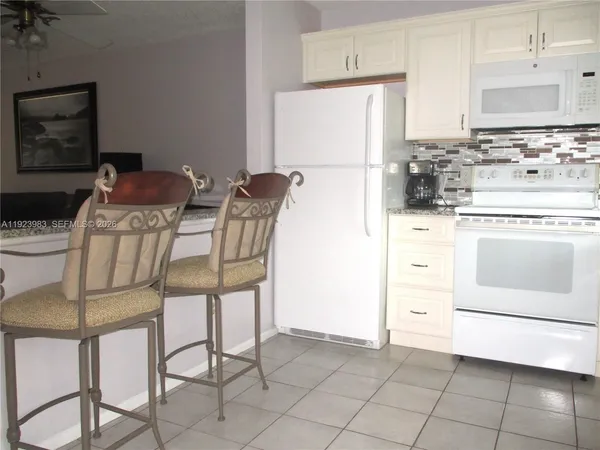 a kitchen with stainless steel appliances a stove a refrigerator and a refrigerator