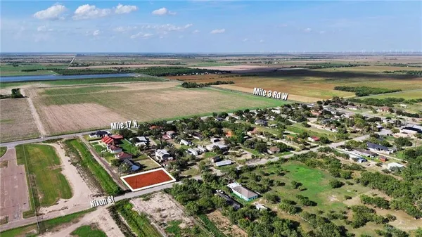 an aerial view of residential houses with outdoor space and swimming pool