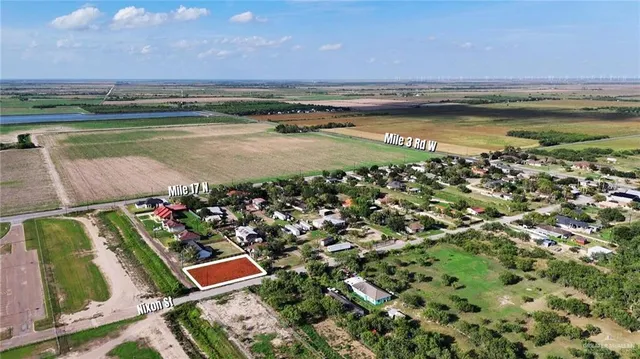 an aerial view of residential houses with outdoor space and swimming pool