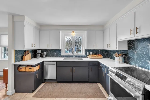 a kitchen with a sink stove and cabinets