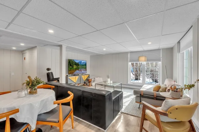 a living room with furniture a window and a flat screen tv