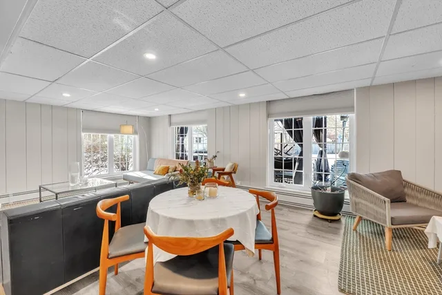 a dining room with furniture and wooden floor