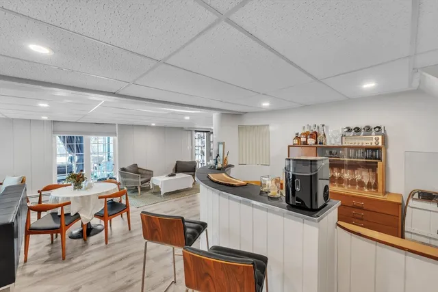 a living room with furniture a flat screen tv and a wooden floor