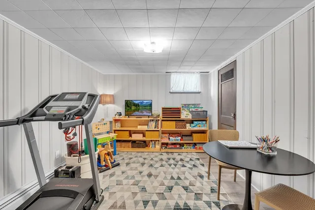 a room with furniture a rug and a window