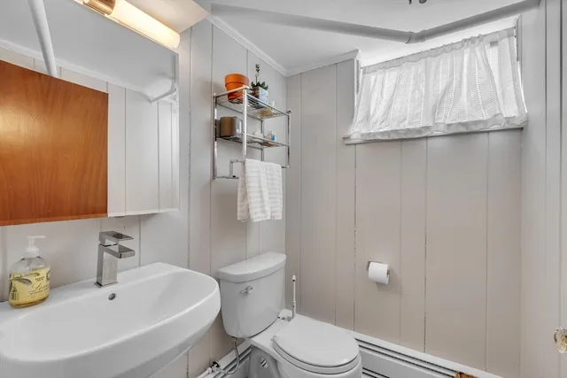 a bathroom with a sink a toilet and shower curtain