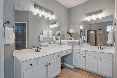 a bathroom with a double vanity sink and a mirror