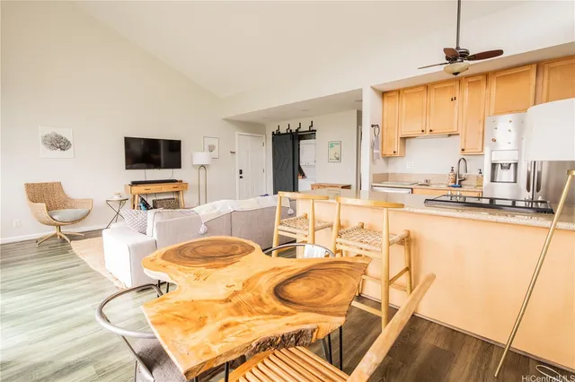 a living room with dining room and wooden floor