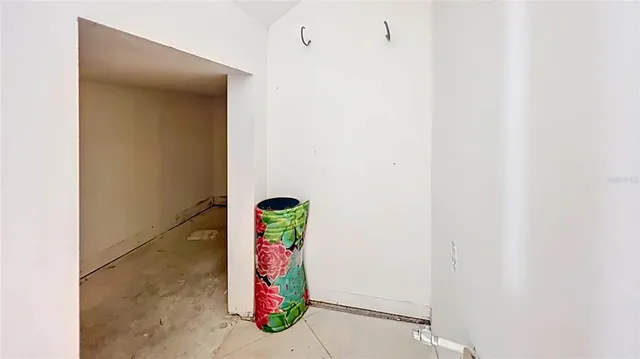 a view of an entryway and hall with a ceiling fan