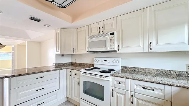 a kitchen with a refrigerator and a sink