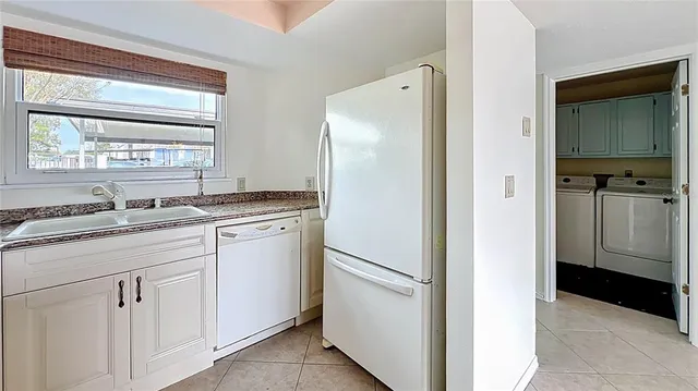 a backyard of a house with a large tree