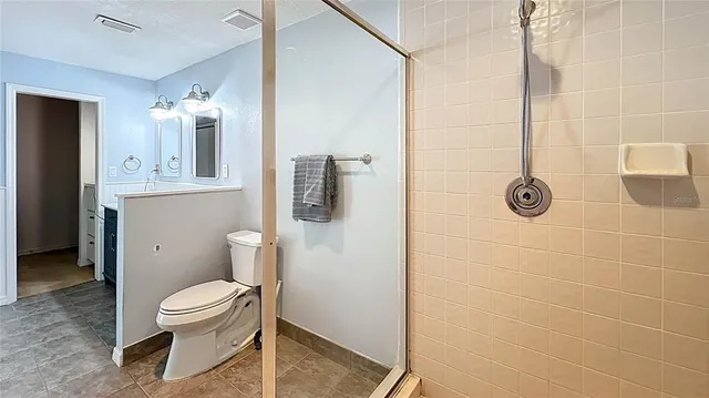 an empty room with a fan and a window