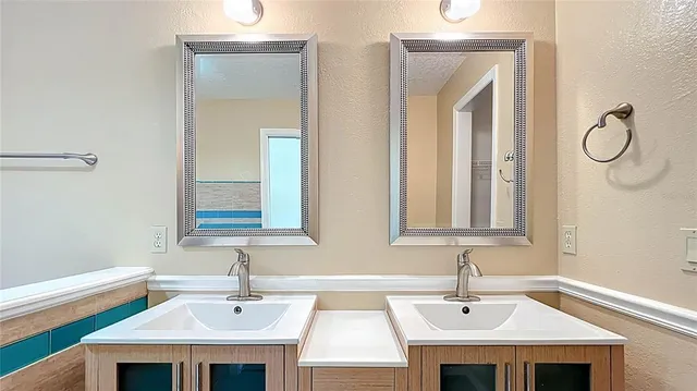 a view of a patio with table and chairs under an umbrella with a fire pit