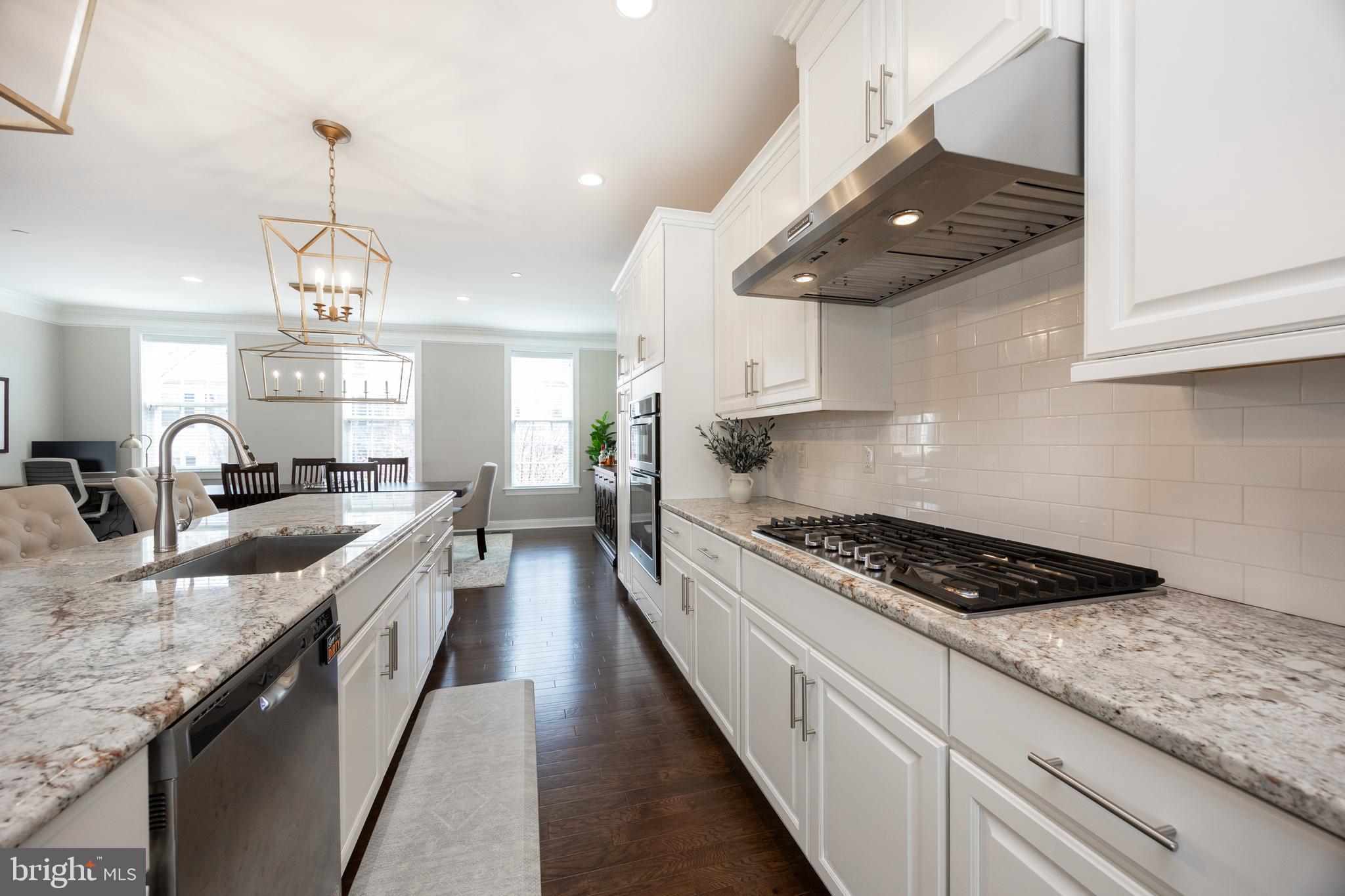 205 Murray Lane Springfield, PA 19064 - Photo 17 of 37 a kitchen with granite countertop stove a sink a refrigerator and blue cabinets