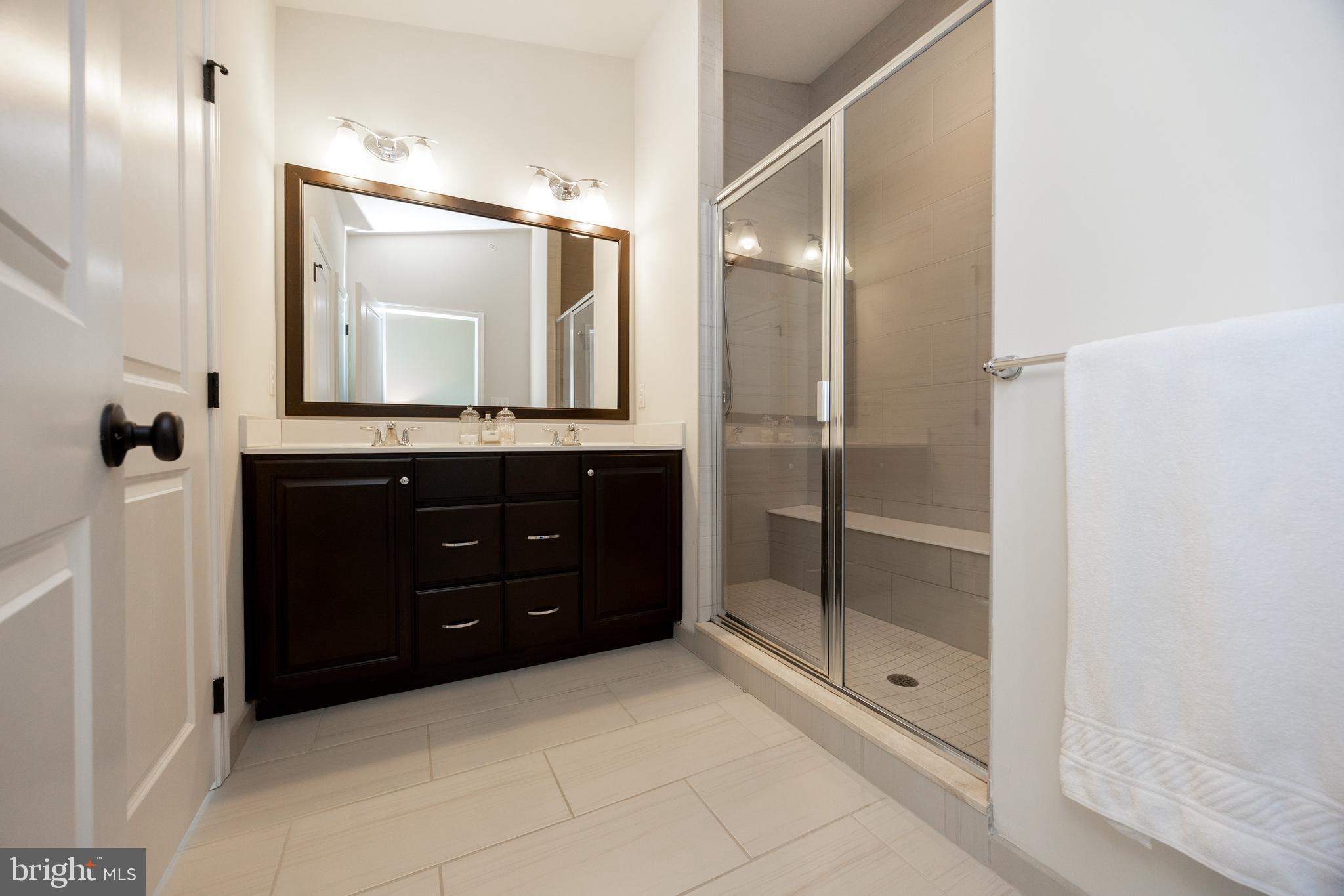 205 Murray Lane Springfield, PA 19064 - Photo 27 of 37 a bathroom with a shower sink and mirror