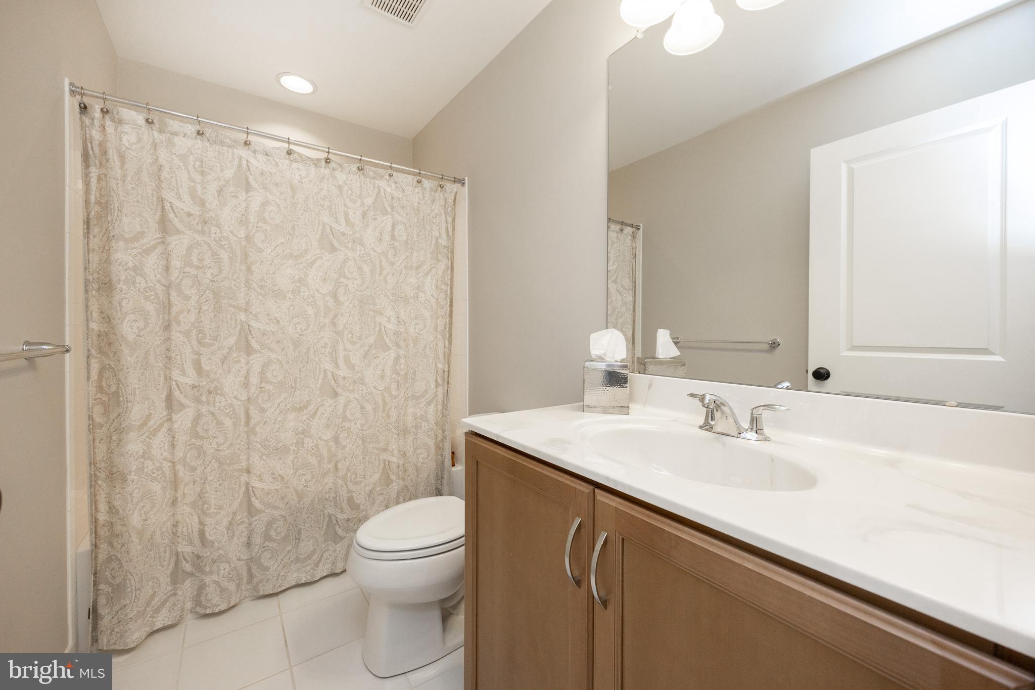 205 Murray Lane Springfield, PA 19064 - Photo 29 of 37 a bathroom with a sink a toilet and shower curtain