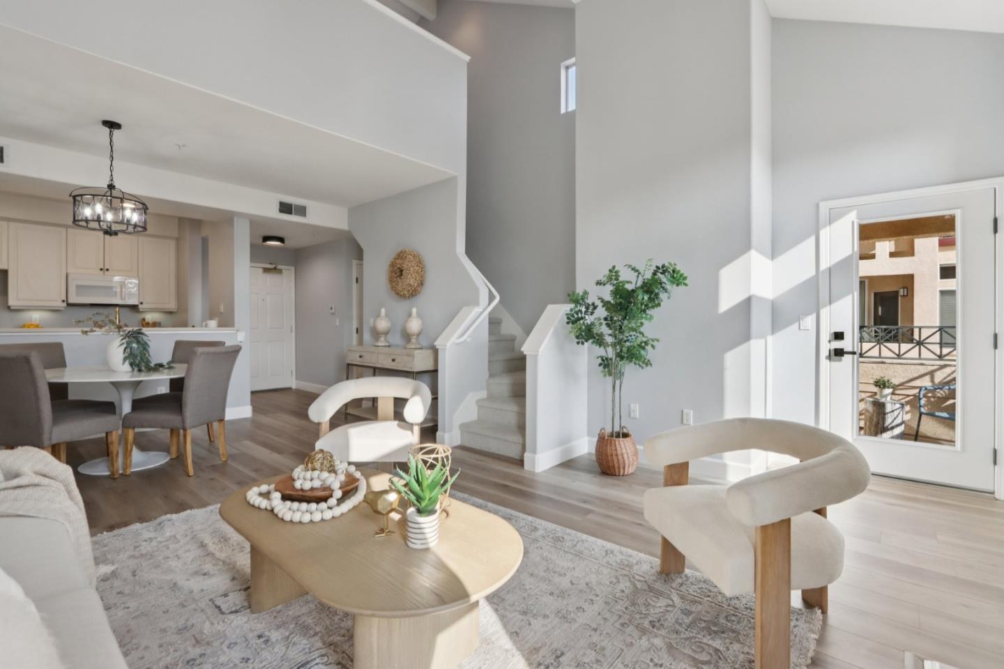 1951 O'Farrell Street, Unit 404 San Mateo, CA 94403 - Photo 6 of 28 a living room with furniture a potted plant and a chandelier