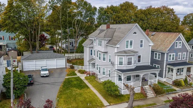 a aerial view of a brick house next to a yard